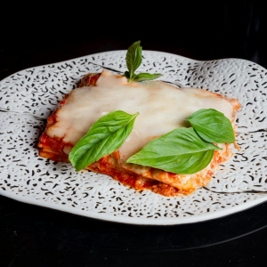 Delicious homemade lasagna with layers of pasta, rich meat sauce and melted cheese, served fresh from the oven.