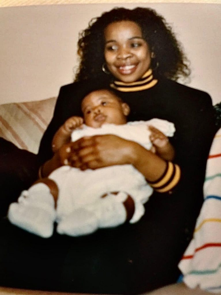 An old photo of Lifa Arosi as a baby, cradled in the arms of his late mother, Suthukazi Arosi. Picture: Supplied