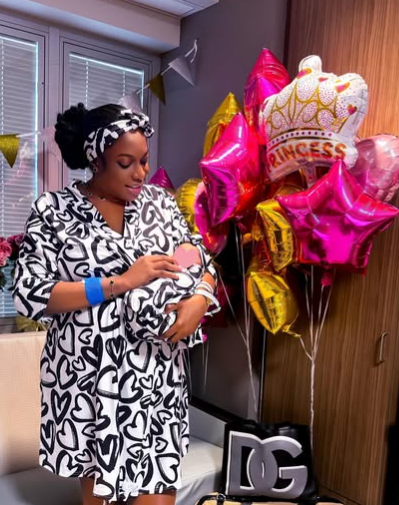 Chika Ike holding her bundle of joy in her arms. Picture: Instagram@ChikaIke