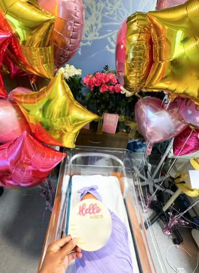 Sleeping beauty: Chika Ike's newborn baby sleeping surrounded by the warm decoration of colourful balloons. Picture: Instagram@ChikaIke