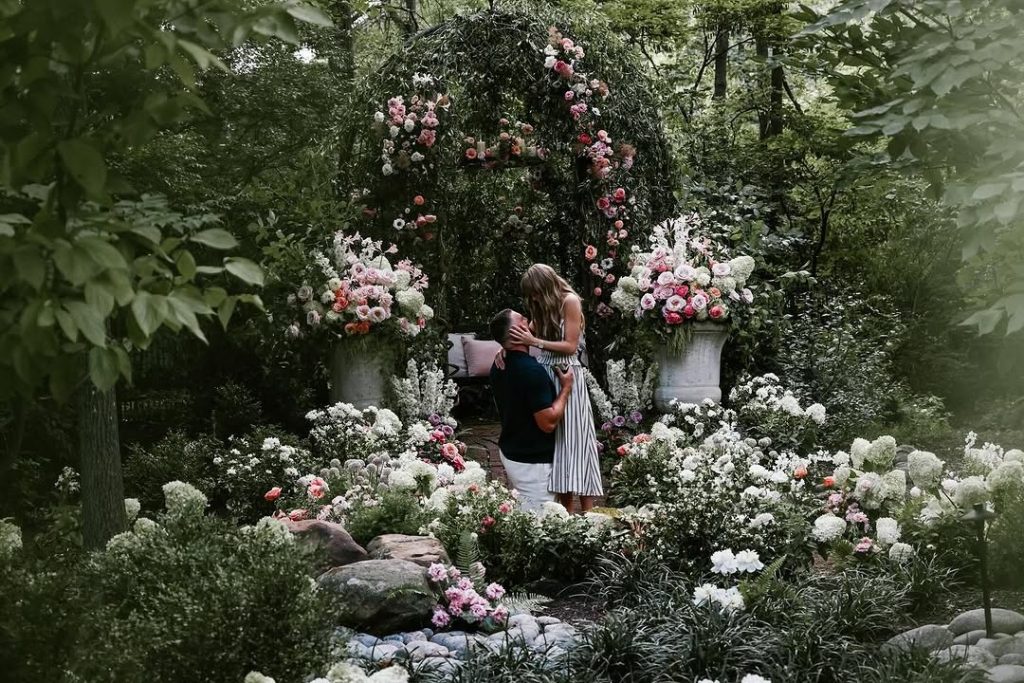 Surrounded by flowers and magic, Travis Kelce kneels before pop royalty, Taylor Swift. Picture: Instagram@TaylorSwift
