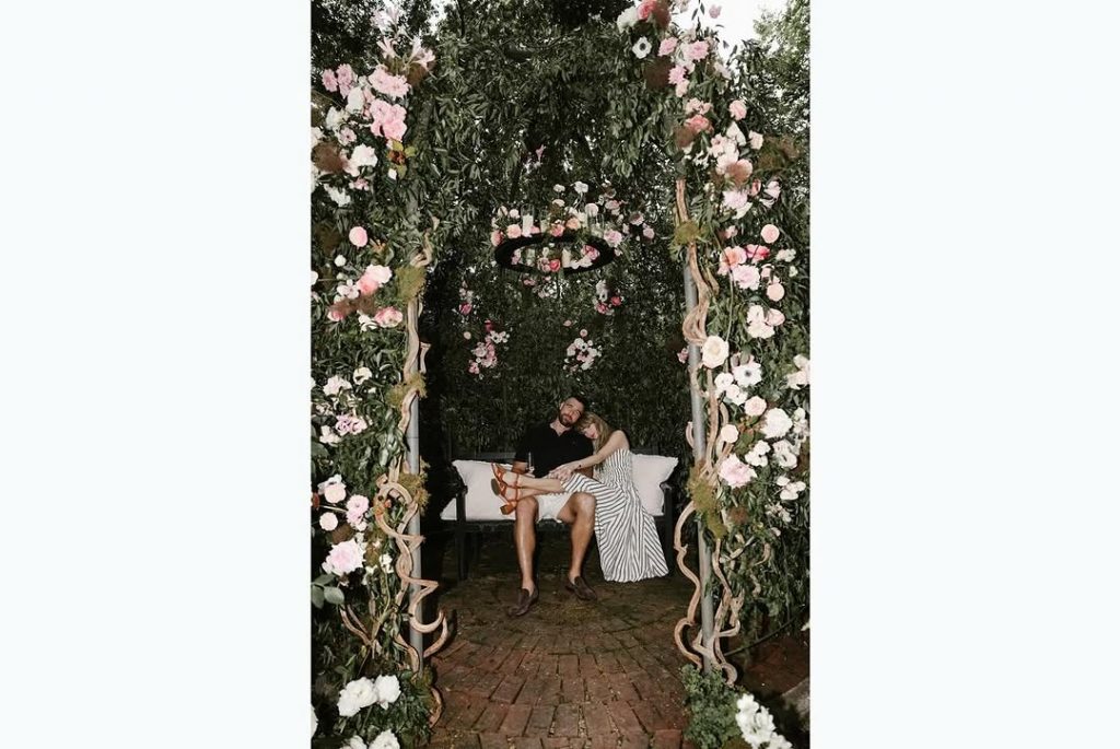 "Till death do us part” — Taylor Swift and fiancé Travis Kelce share a tender moment, seated side by side in a flower-filled garden, celebrating their love. Picture: Instagram@TaylorSwift