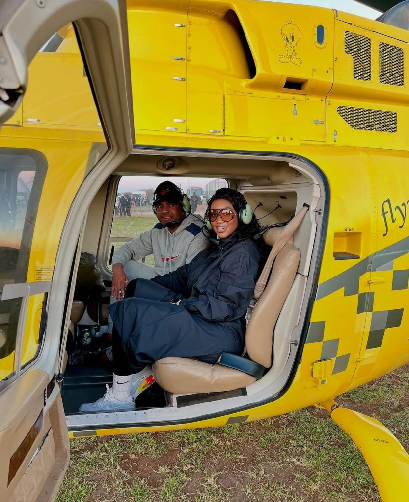Ready for takeoff? Power couple Itumeleng Khune and wife Sphelele Makhunga are all set inside the chopper to tour Zimbabwe on their vacation. Picture: Instagram@ItumelengKhune