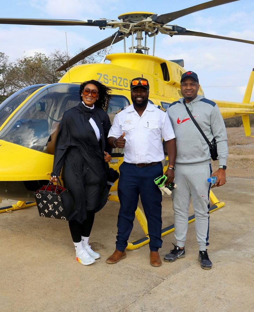 The power couple, Itumeleng Khune and his wife Sphelele Makhunga, strike a pose with their pilot before taking off on a chopper tour around Zimbabwe. Picture: Instagram@ItumelengKhune