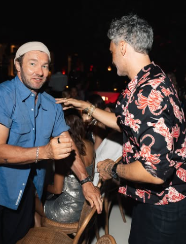 Taika Waititi, the star of the night, enjoying laughs and catching up with a friend. Picture: Instagram@RitaOra