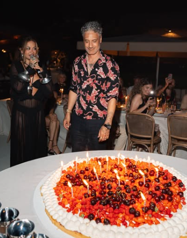 Rita Ora delivers a speech for hubby at his birthday bash while guests sit attentively, capturing the moment. Picture: Instagram@RitaOra