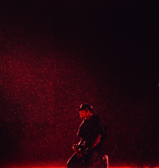 Kneeling in the rain, drenched and unbothered, Chris Brown let the crowd’s energy wash over him. Picture: Instagram@ChrisBrown
