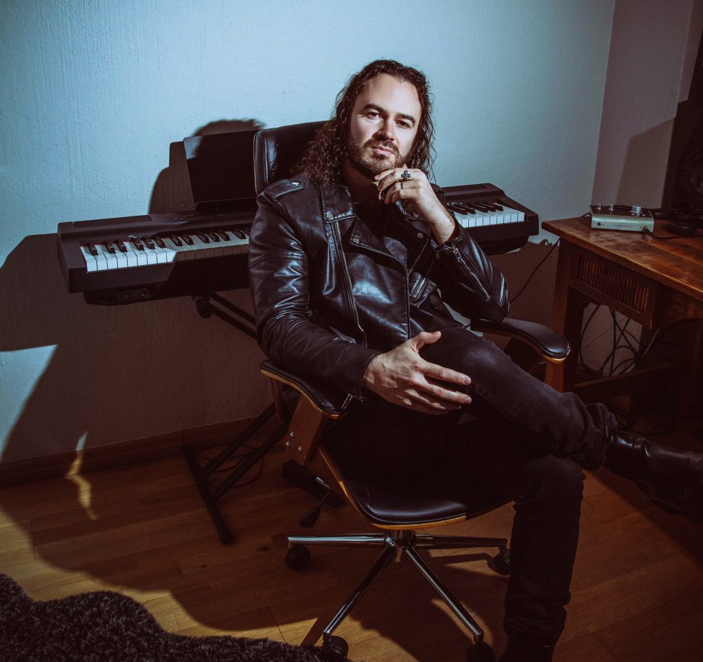 Chart-topping artist Daniel Baron, sitting like the director that he is, commanding the studio. Picture: Supplied