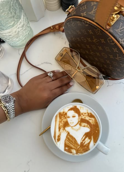 Lerato Kganyago enjoyed a peaceful moment at a chic Miami restaurant, with her brown leather bag, designer accessories, and a cappuccino topped with her own image. Picture: Instagram@LeratoKganyago