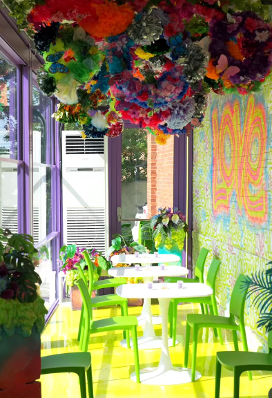 Green chairs and pops of colour from beautiful flowers set the scene outside the venue. Picture: Instagram@Monicadenise