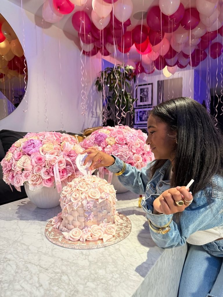 Sami admiring and gently touching her stunningly decorated birthday cake. Picture: Instagram@WinnieHarlow