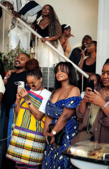 Guests, dressed in vibrant traditional attire, gather around snapping photos of the happy couple. Picture: Instagram@NtandoRambani