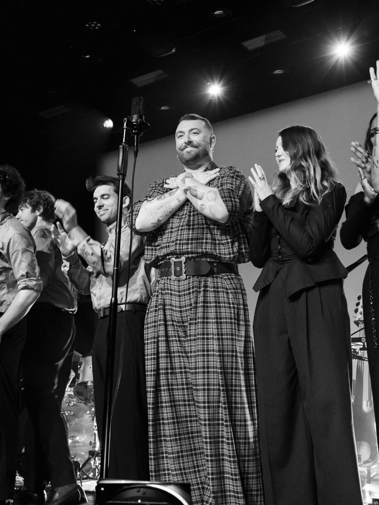 Sam Smith standing tall on stage with his team beside him. Picture: Instagram@SamSmith