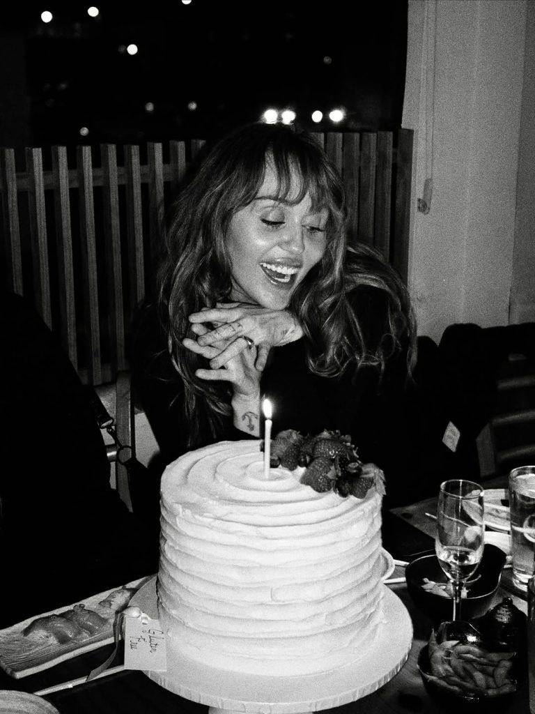 With a radiant smile, Miley Cyrus poses in front of her birthday cake. Picture: Instagram@MileyCyrus