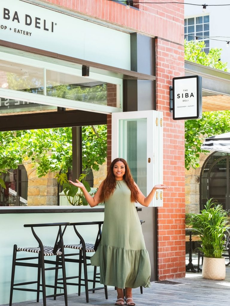 Siba, the star of the moment, beaming outside her new food shop. Picture: Instagram@SibaMtongana