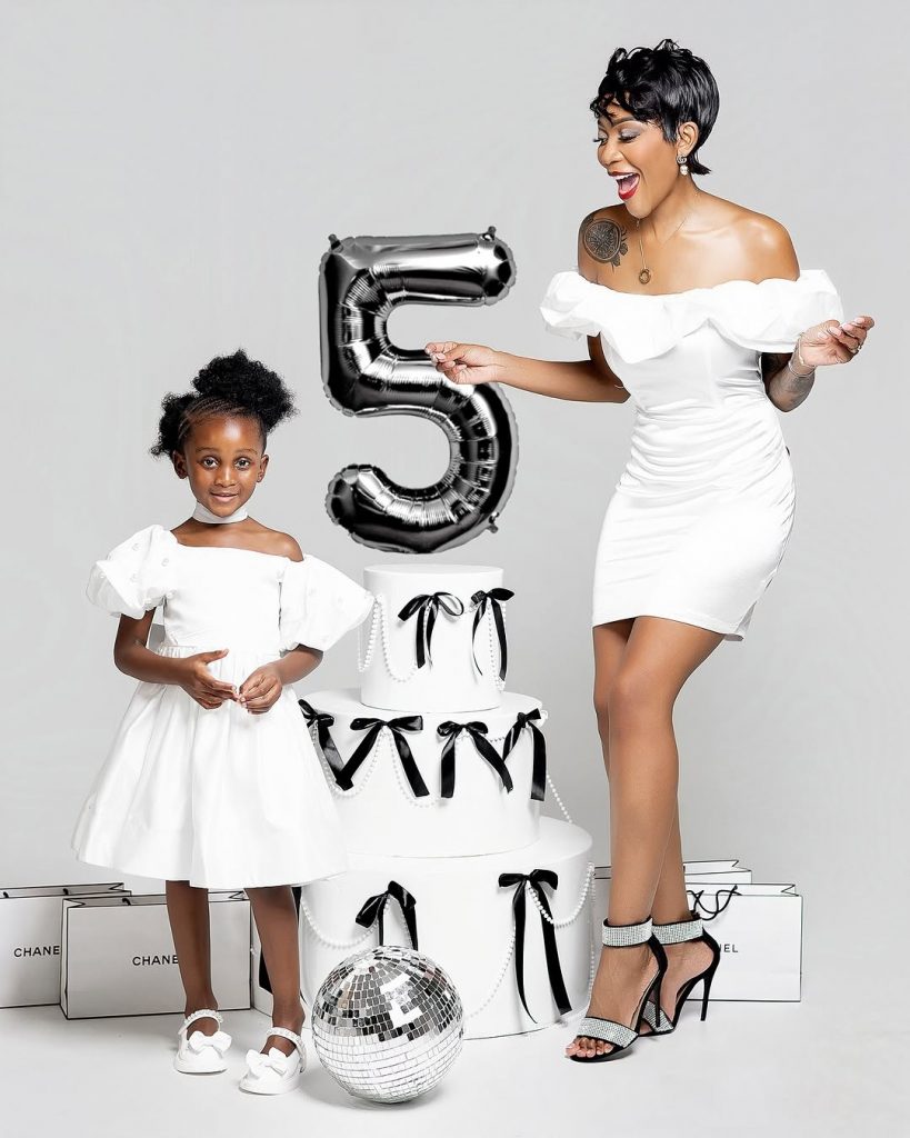 Paris and her mom Happy Simelane beaming with joy in their lovely white outfits. Picture: Instagram@HappySimelane