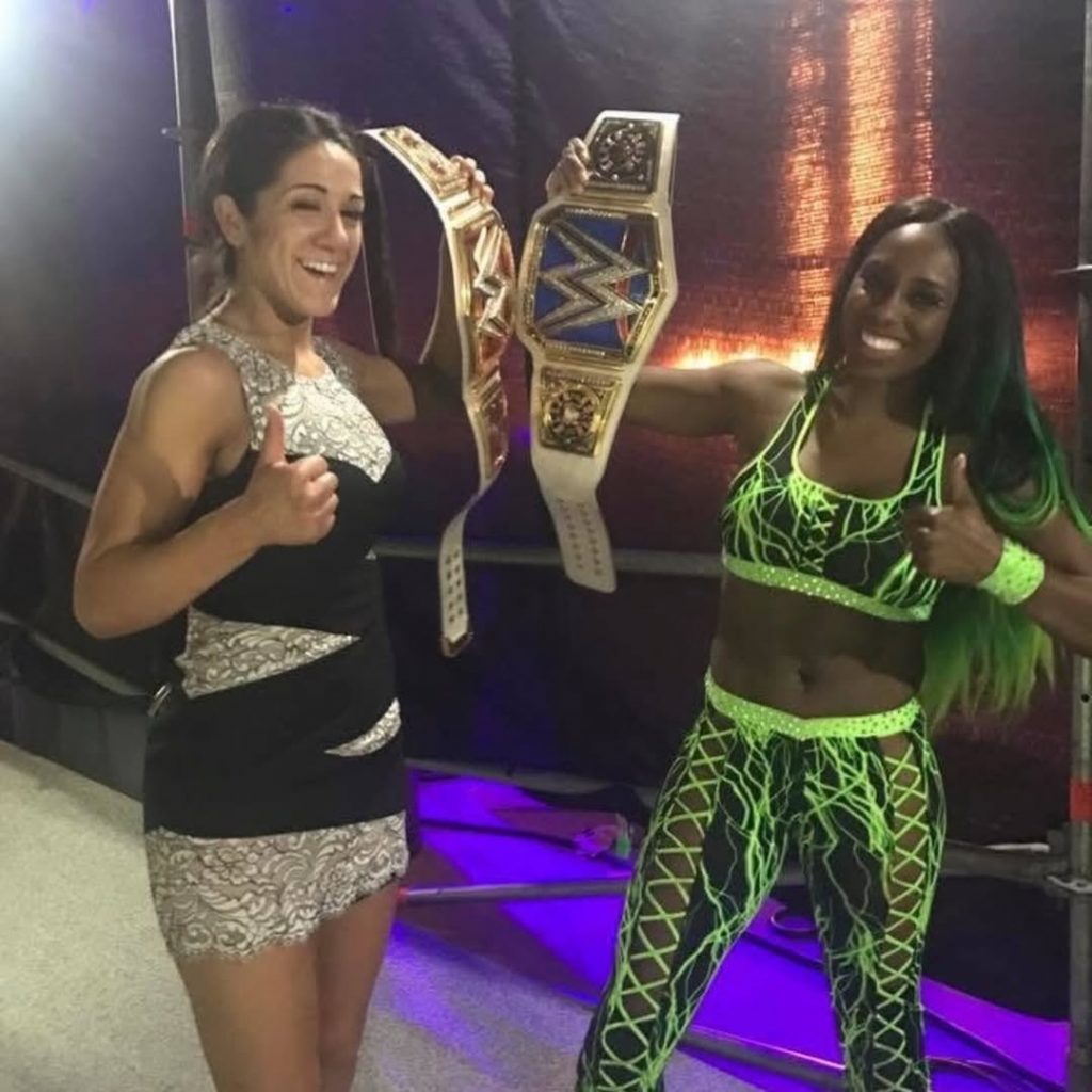 Bayley and Naomi proudly posing with their WWE championships backstage. Picture: Instagram@Bayley
