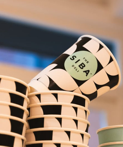 Stylish takeaway coffee cups proudly featuring Siba’s Foodshop branding. Picture: Instagram@SibaMtongana