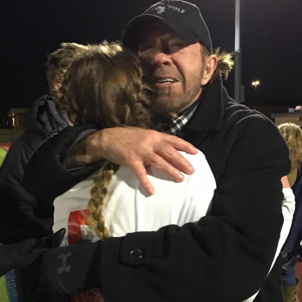 A recent snapshot of the late Chuck Norris holding a now-grown Greta Norris close in a tight, affectionate embrace. Picture: Instagram@GretaNorris