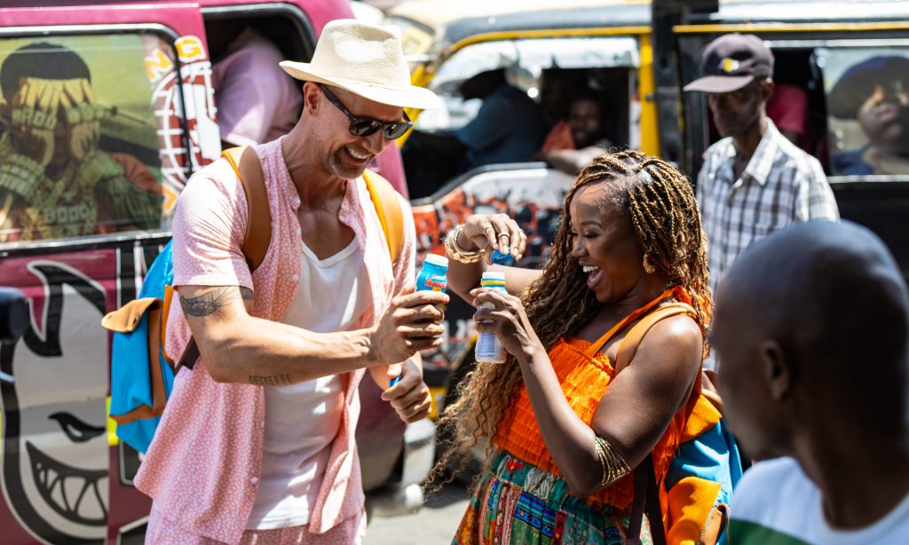 The duo open their Tropika bottles while exploring the bustling streets of Mombasa. Picture: Supplied