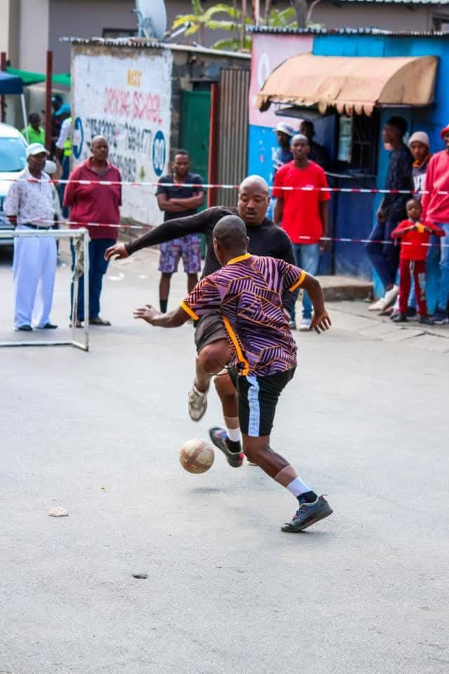 Young men locked in an exciting street soccer match. Picture: Supplied