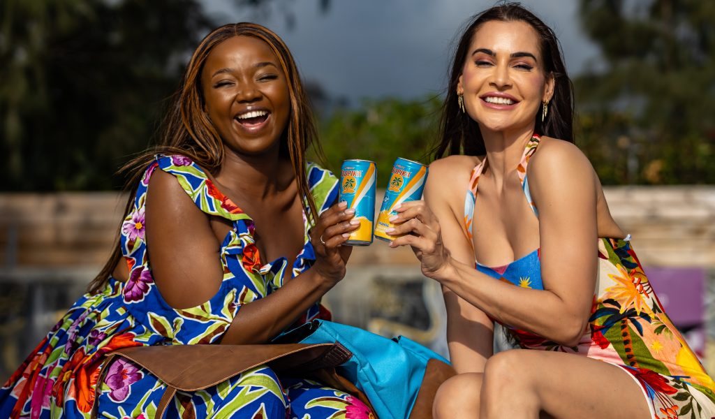 The duo shared smiles as they clinked their Tropika cans together. Picture: Supplied