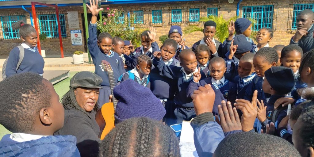 Condry playing guitar for school learners at Mc Weiler Primary School in Alexandra. Picture: Supplied