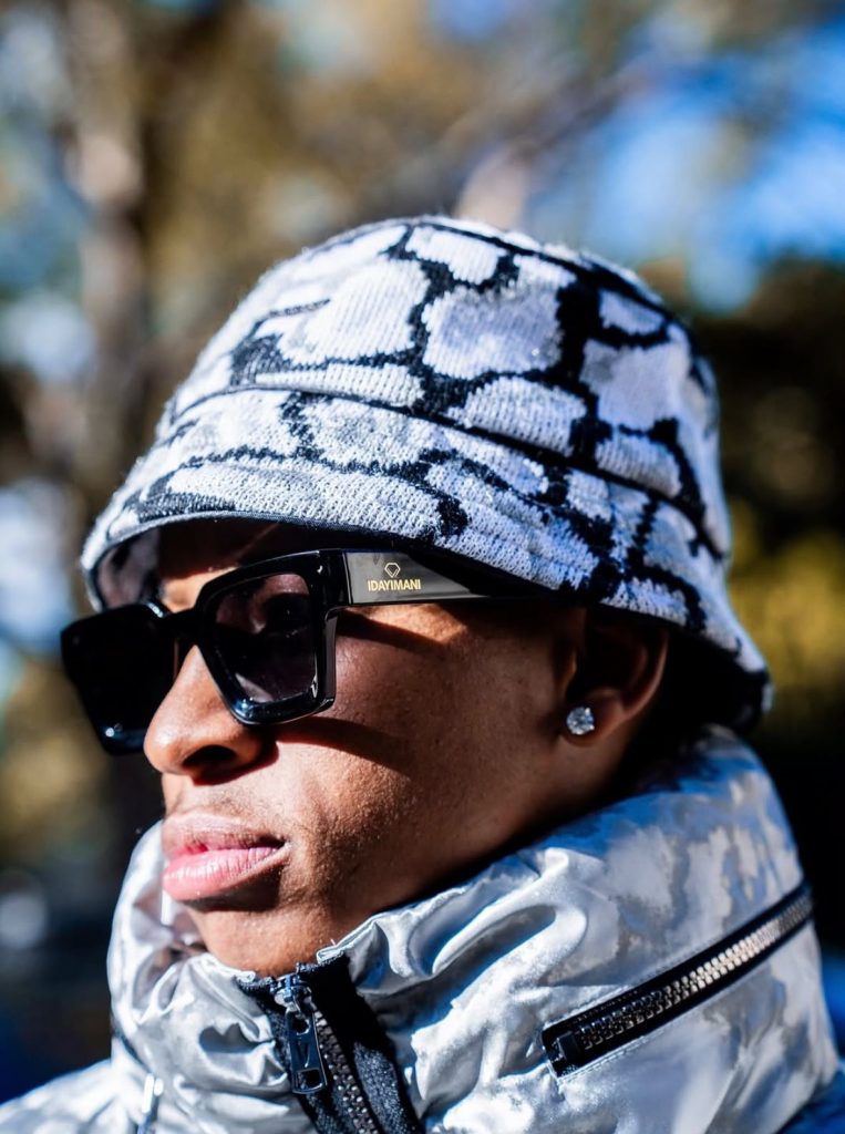 Zille wearing IDAYIMANI's Crown Black Bucket Hat, paired with IDAYIMANI's Black Millionaire Logo Sunglasses. Picture: Supplied
