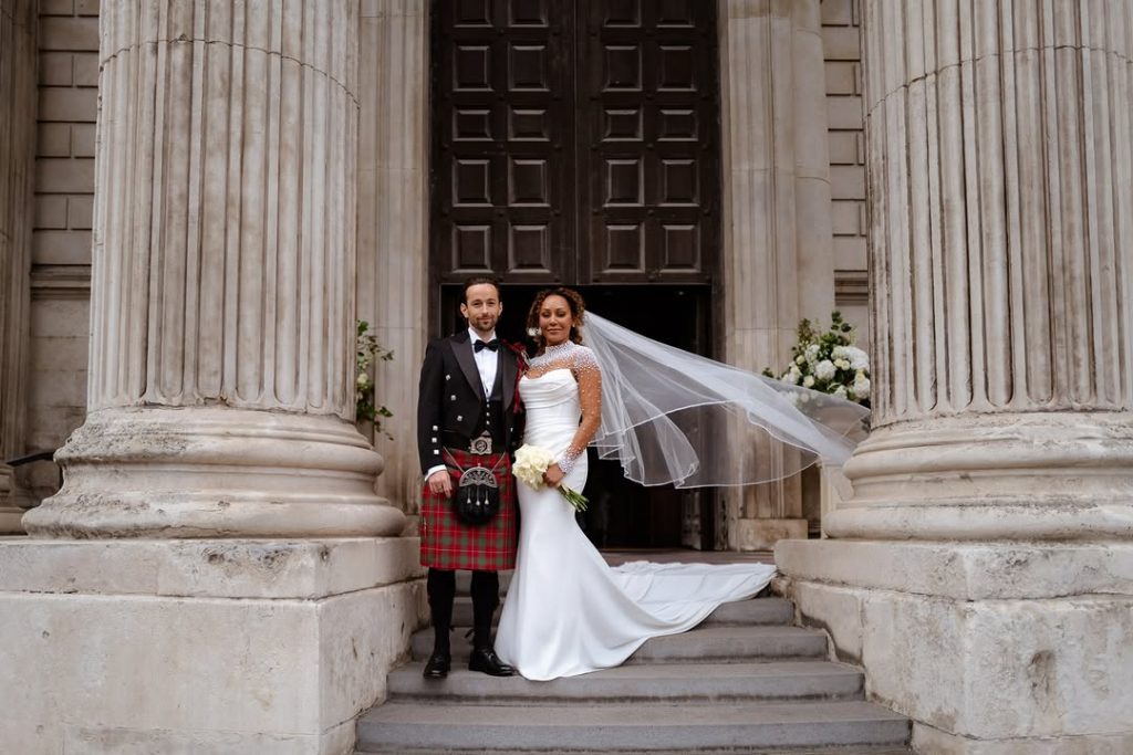 The husband and wife posed for a photo outside the wedding venue on their wedding day. Picture: Instagram@OfficialMelB