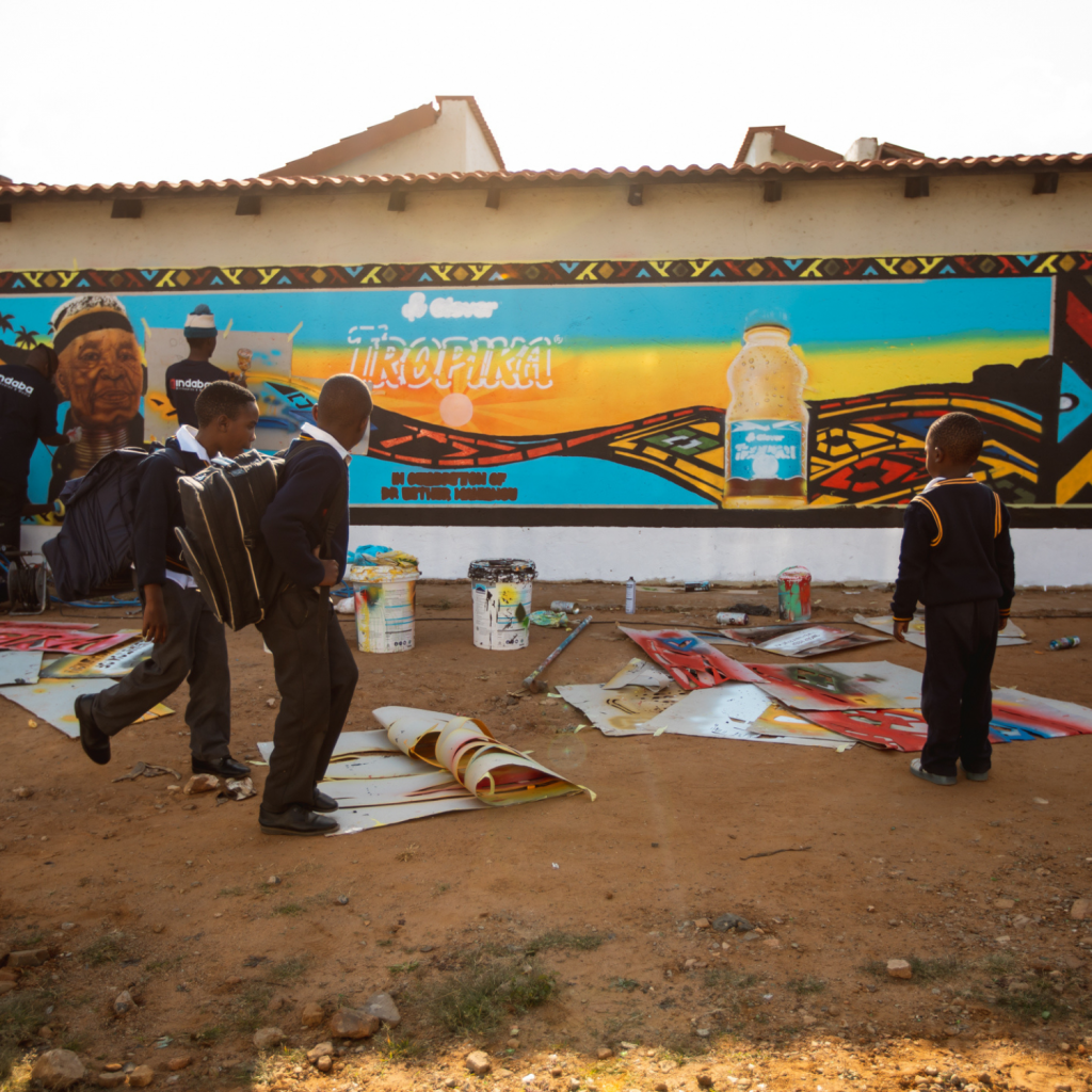 School learners take in the striking Dr Esther Mahlangu-inspired mural celebrating South African artistry. Picture: Supplied